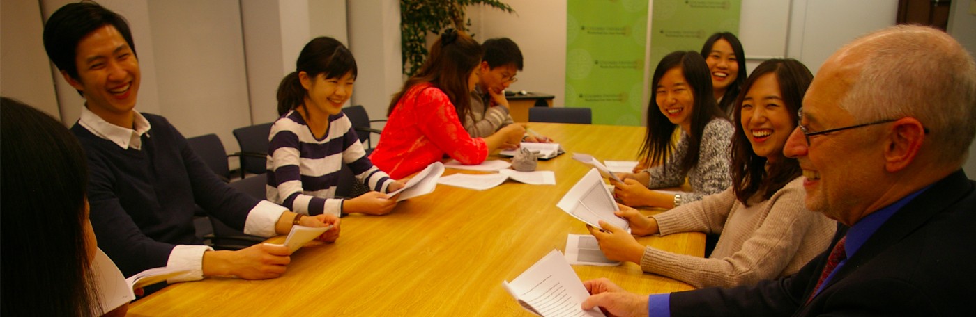 people around desk talking and laughing