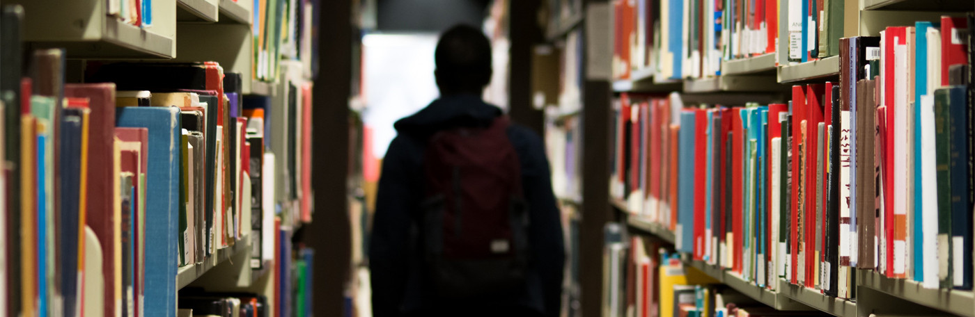man's back in a library